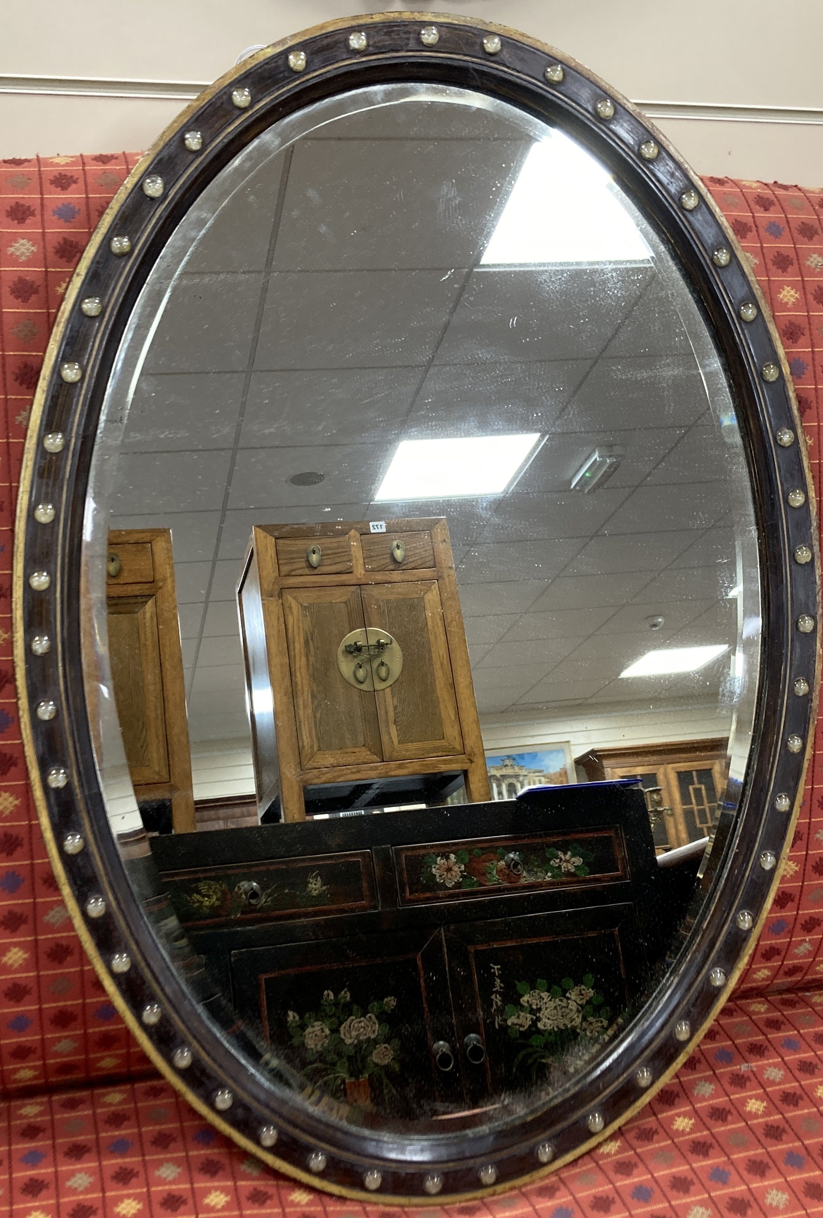A 19th century oval Irish wall mirror with painted simulated grain, width 59cm, height 83cm